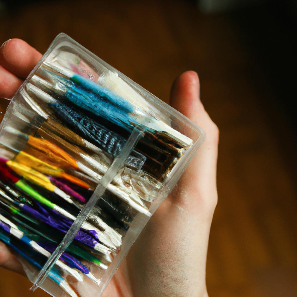 Person holding cross stitch supplies