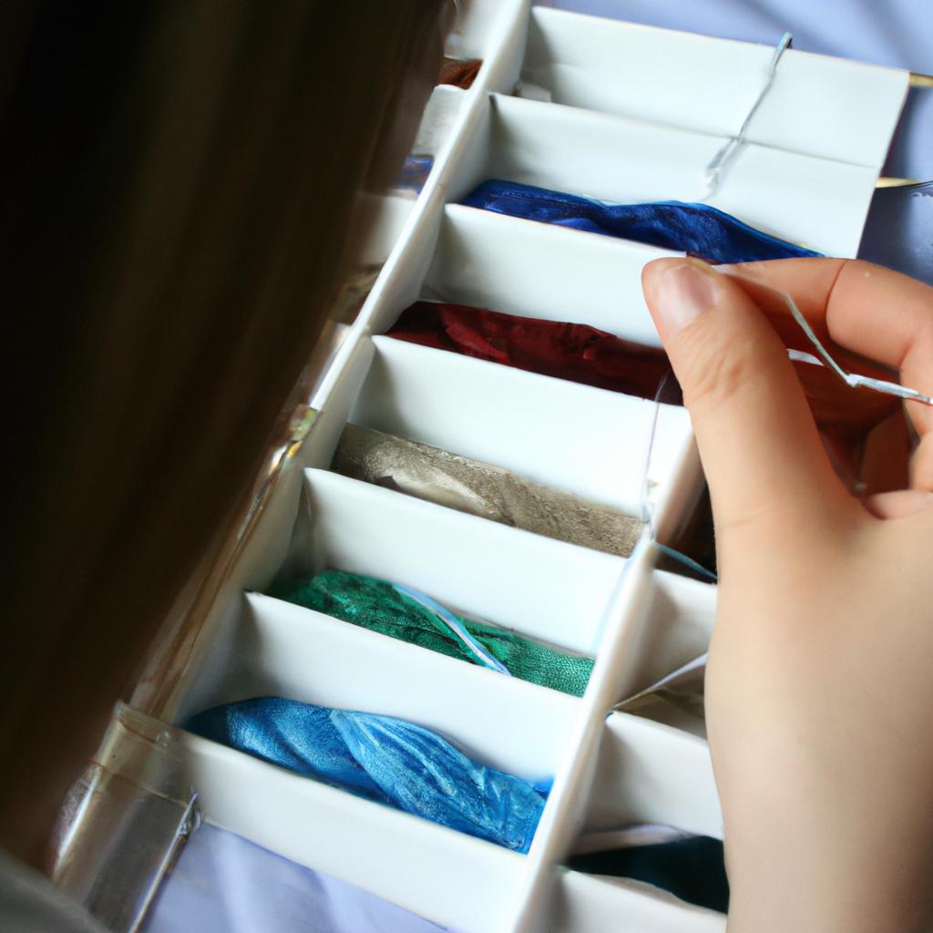Person selecting thread for cross-stitch